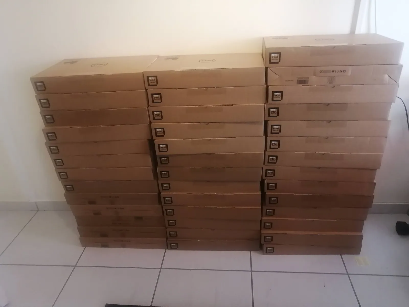 Stack of boxed Dell laptops ready for delivery to a client